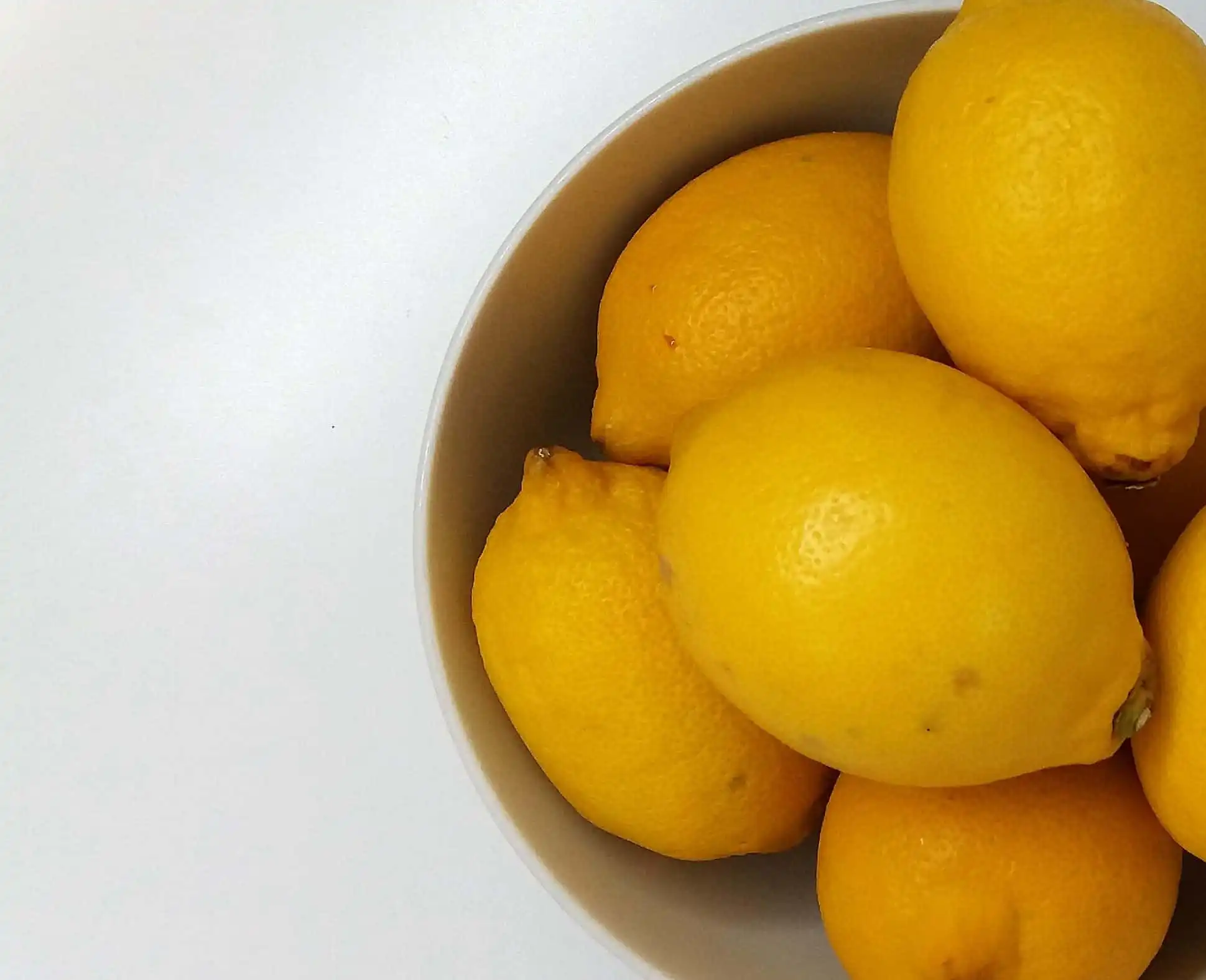 bowl of lemons against a white background