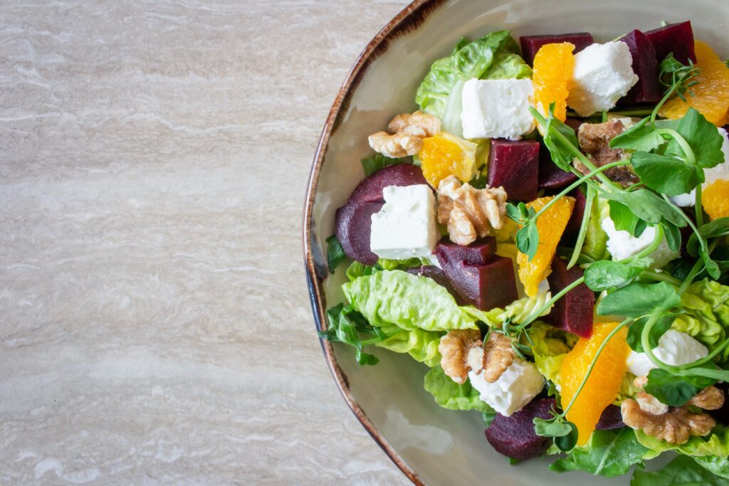High fat diets and your gut microbiome 3 Close up of bowl of salad with feta, olives, yellow pepper and lettuce.