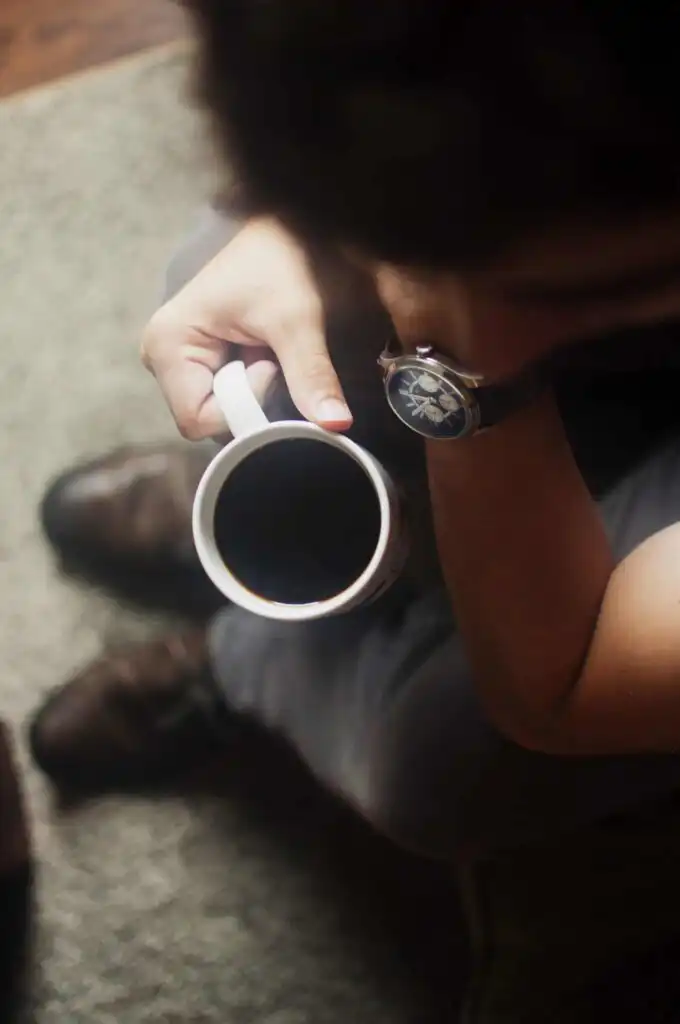 how-to-gain-weight-with-ibs-2 blurred person bending over a cup of black coffee