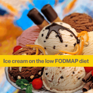 Close up of a bowl of different coloured ice-cream scoops with some chocolate sauce on. Ice cream appears to have one scoop of vanilla, 2 chocolate scoops and one strawberry.