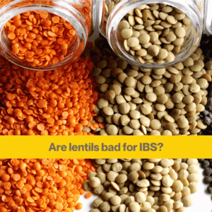 Close up of two glass bottles on their side spilling out dried red lentils, and brown lentils. Words 'are lentils bad for IBS'