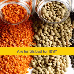 Close up of two glass bottles on their side spilling out dried red lentils, and brown lentils. Words 'are lentils bad for IBS'