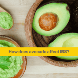 wooden bowl with an avocado cut open, smaller wooden bowl with mashed avocado. The words How Does avocado affect IBS