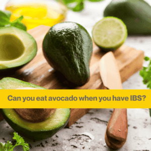 chopping board with one cut up avocado and one whole avocado on a table. Words can you eat avocado when you have IBS