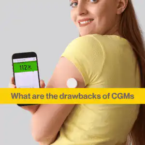 White woman with long brown hair looks over her shoulder at the camera, She has a CGM in her arm and is showing the camera the screen which says 112 and has a green banner across the top.