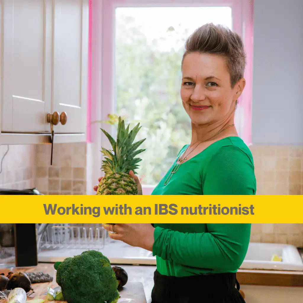 Anna Mapson, an IBS nutritionist, stands in a kitchen holding a pineapple 